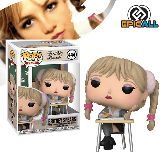 Un Funko POP de Britney Spears con el atuendo de colegiala de su video musical "Baby One More Time". Lleva una camisa gris atada, una falda negra, medias negras hasta el muslo y zapatos negros. Tiene el pelo rubio recogido en dos coletas con lazos rosas y está sentada en una silla escribiendo en un papel. La figura tiene un diseño característico de Funko POP, con cabeza grande y ojos redondos.