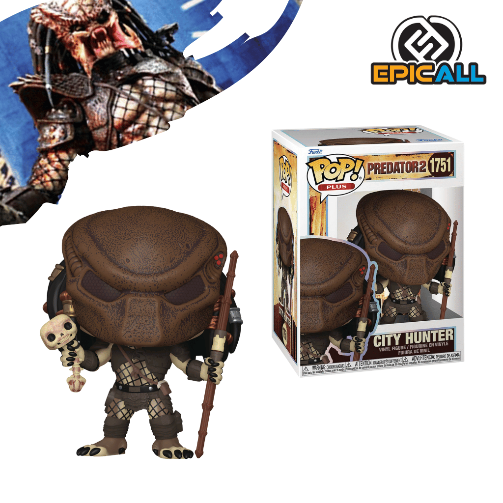 Un Funko POP del Predator City Hunter. La figura tiene una máscara facial marrón con ranuras, rastas que caen por la espalda, y armadura detallada de color gris oscuro y bronce. Sostiene un bastón largo con una calavera al final en su mano izquierda. La figura tiene los ojos grandes y redondos, característicos de los Funko POP. La caja del Funko POP se ve detrás de la figura.