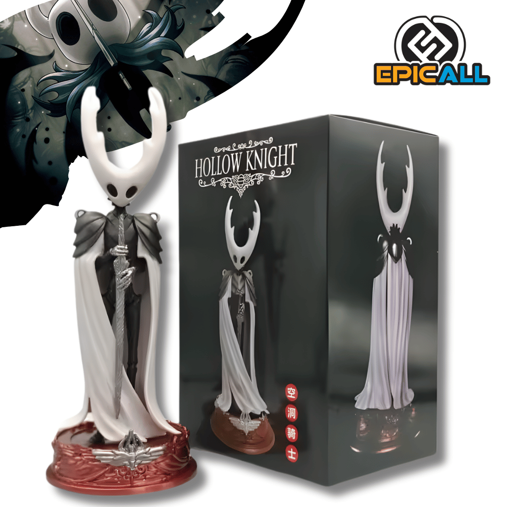 Una figura de estatua del Caballero (The Knight) del videojuego Hollow Knight, de unos 24 cm. El personaje tiene una cabeza blanca con cuernos, lleva una capa blanca y negra y sostiene una espada delgada. La figura está de pie sobre una base circular de color rojo.