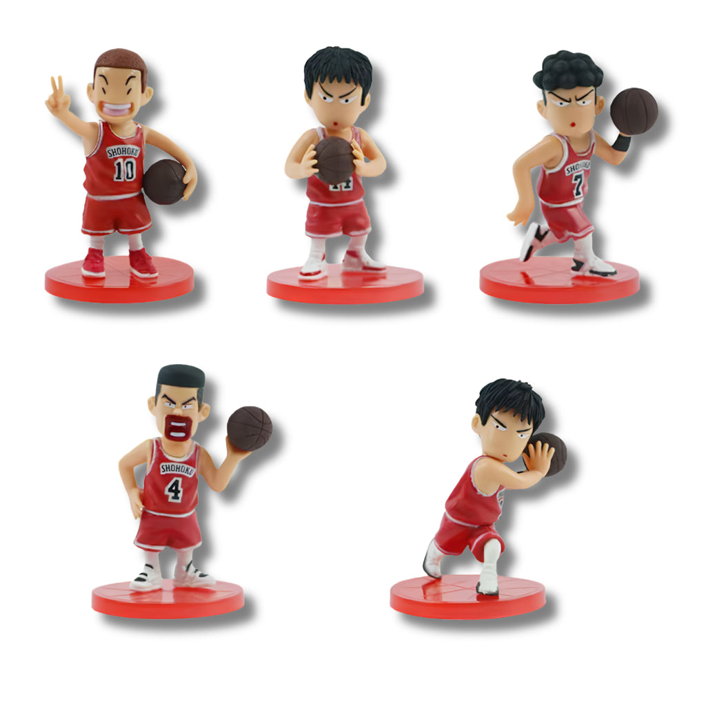 Set de 5 figuras coleccionable tipo gachapon con las alineaciones titulares del equipo Shohoku de Slam Dunk en estilo chibi: Hanamichi Sakuragi (#10), Kaede Rukawa (#11), Ryota Miyagi (#7), Takenori Akagi (#4) y Hisashi Mitsui (#14), vistiendo el uniforme rojo de básquetbol sobre bases circulares rojas.