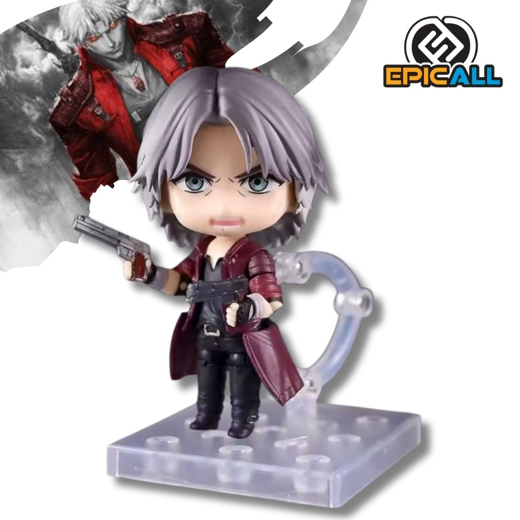 Figura articulada coleccionable tipo Nendoroid de 10 cm de altura de Dante de Devil May Cry, luciendo abrigo rojo, cabello plateado, sosteniendo sus pistolas gemelas Ebony e Ivory y posando sobre una base transparente con soporte.