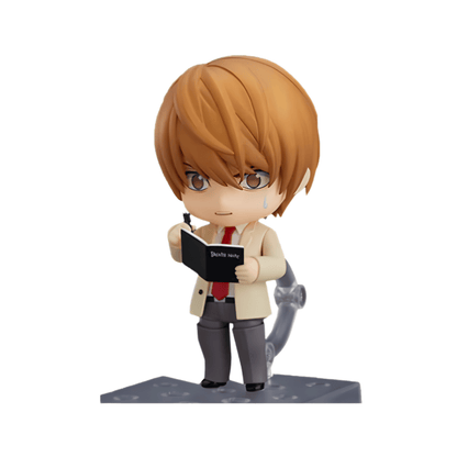 Figura coleccionable estilo Nendoroid de Light Yagami #1160 de Death Note, vistiendo uniforme escolar y escribiendo en su libreta Death Note con expresión tensa, sobre una base de soporte y con una altura aproximada de 10 cm