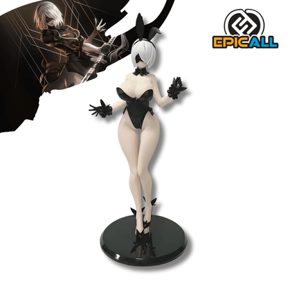 Una figura de estatua de la androide 2B del videojuego NieR Automata, de unos 19 cm de altura, vestida con un traje de conejita negro, guantes y orejas de conejo. La figura está de pie sobre una base circular negra y tiene su vendaje negro característico sobre los ojos.