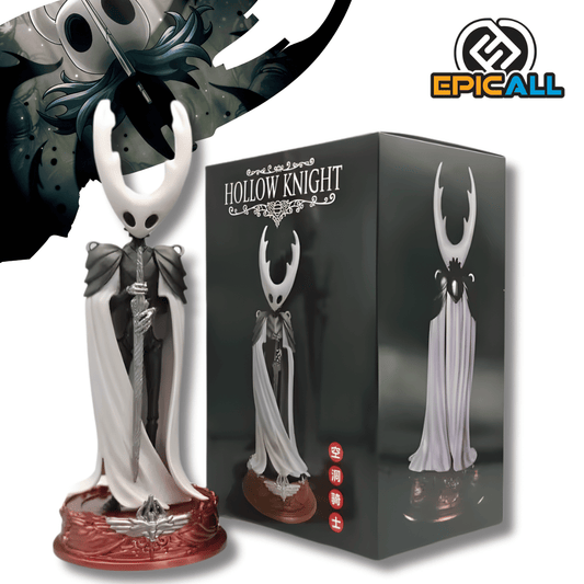 Una figura de estatua del Caballero (The Knight) del videojuego Hollow Knight, de unos 24 cm. El personaje tiene una cabeza blanca con cuernos, lleva una capa blanca y negra y sostiene una espada delgada. La figura está de pie sobre una base circular de color rojo.