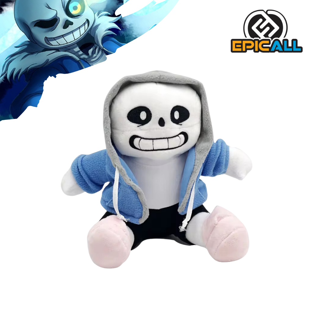 Un peluche de Sans, un personaje del videojuego Undertale. Es de color blanco y azul, con una gran sonrisa y ojos en forma de óvalo. Lleva una sudadera azul y pantalones cortos negro