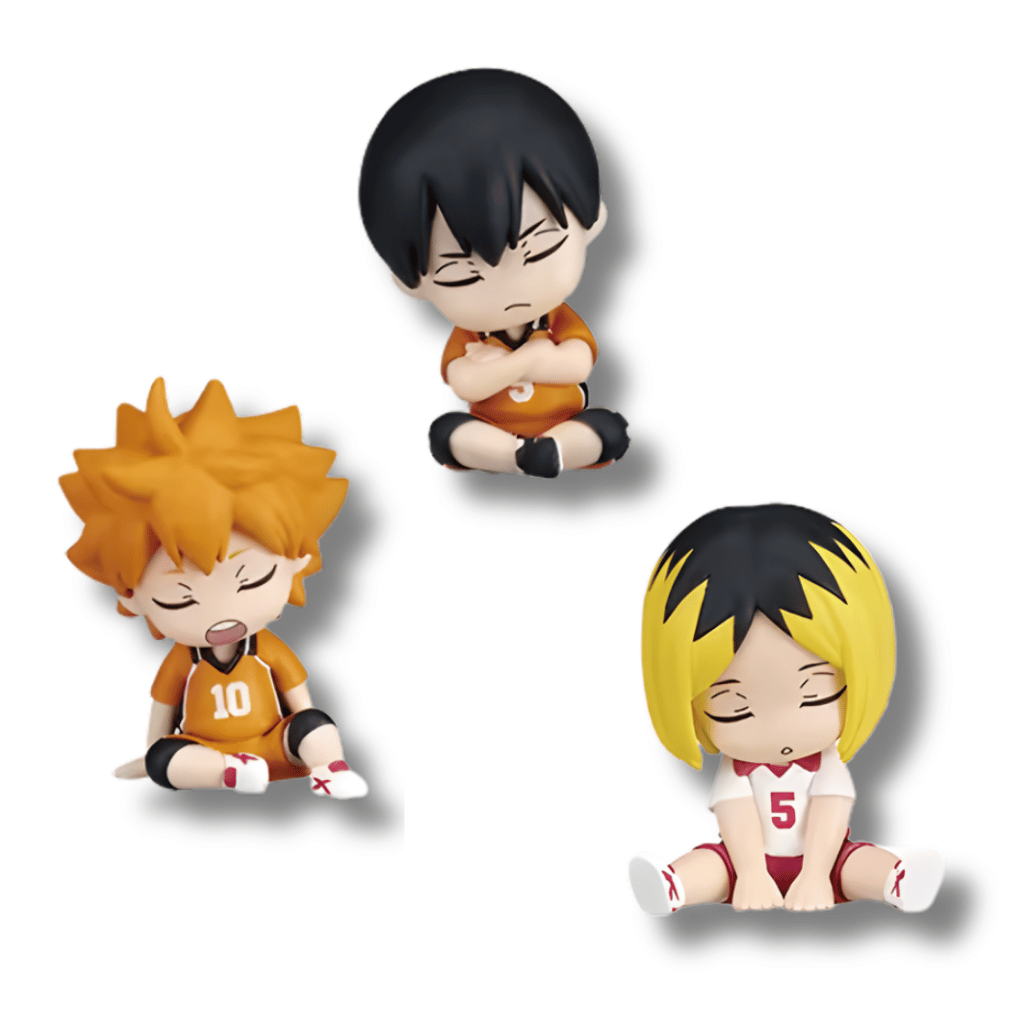 Un set de tres mini figuras coleccionables de estilo chibi de personajes del anime Haikyuu!!. Las tres figuras están sentadas con los ojos cerrados, simulando que duermen. Los personajes son Hinata (cabello naranja, uniforme naranja #10), Kageyama (cabello negro, uniforme naranja) y Kenma (cabello rubio y negro, uniforme blanco #5).